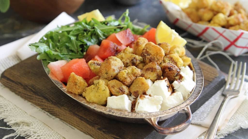 Watermelon feta salad with fried bay scallops in a metal bowl.
