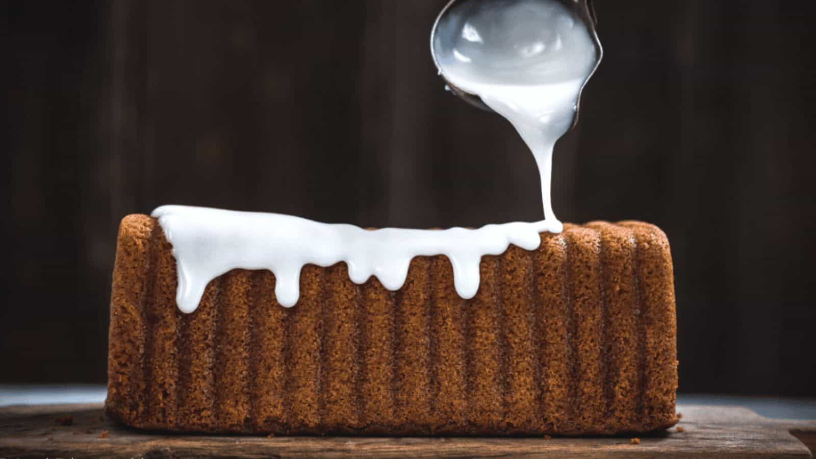 Quick 3-ingredient icing glaze for brownies, cookies, and cakes being poured over loaf of sweet bread.