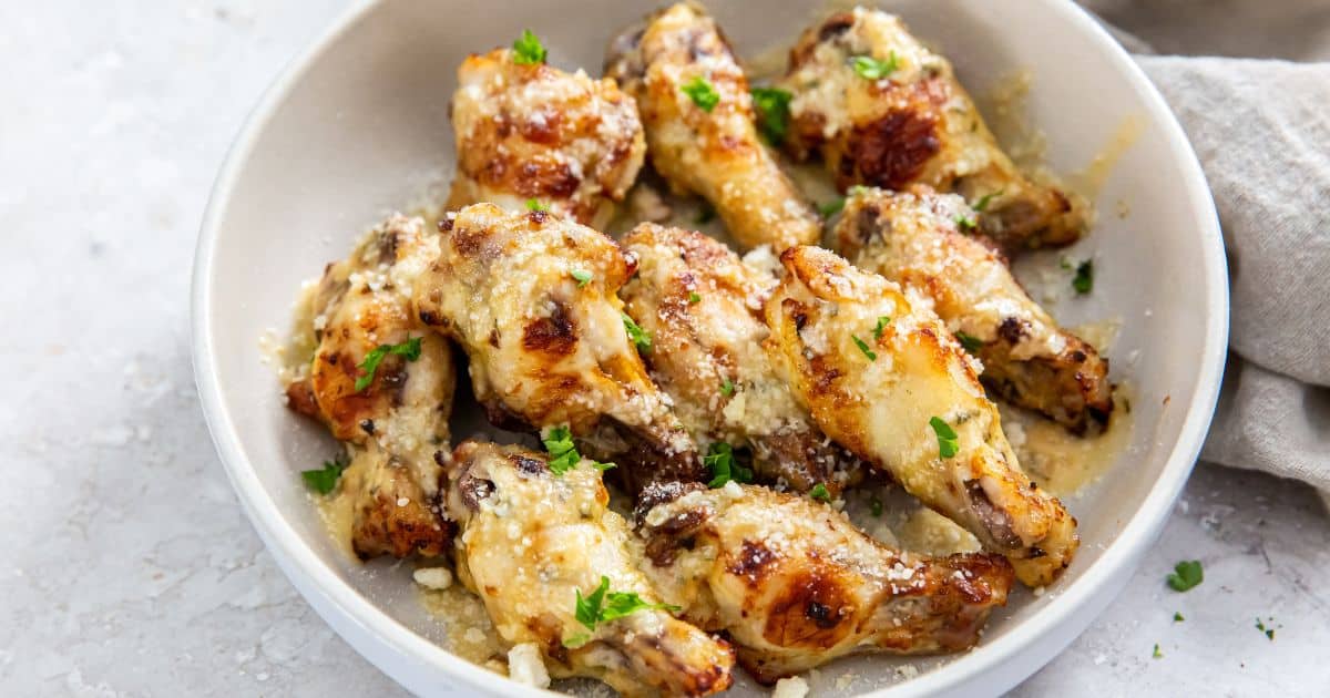 Air Fryer Garlic Parmesan Wings in a white bowl with parsley.