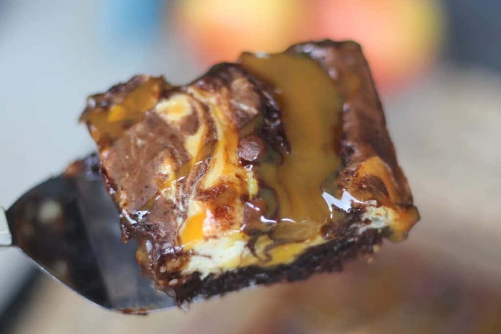 Close up of a caramel apple cheesecake brownie.