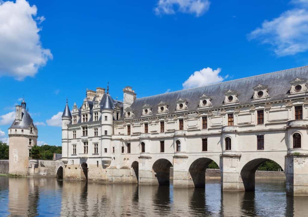 A French castle built on stilts stretches across a river in the Loire Valley.