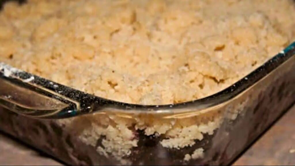 Image shows a closeup of a Cherry Berry Crisp in a glass pyrex dish.