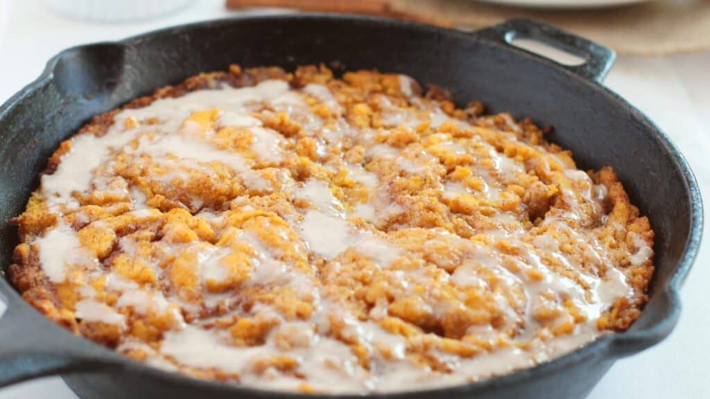 Cinnamon roll pumpkin cake in skillet.