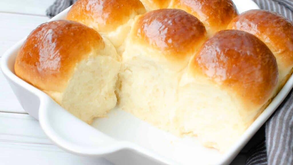 Condensed milk dinner rolls in pan.