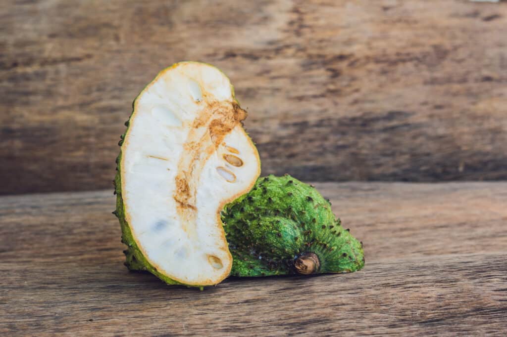 Guanabana on an old wooden background - exotic tropical fruit - regional fruits from Vietnam.
