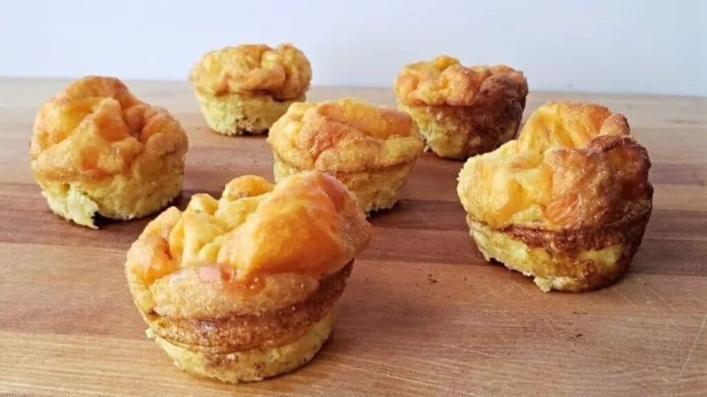 Image shows Egg Muffins sitting on a wooden board.