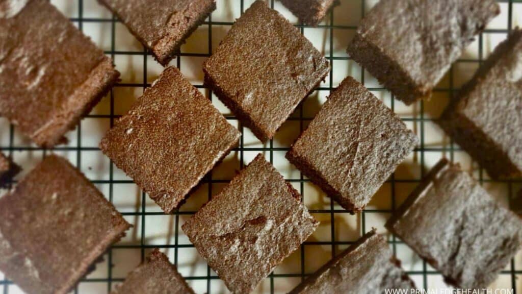Flourless brownies cut and cooling on a wire rack.
