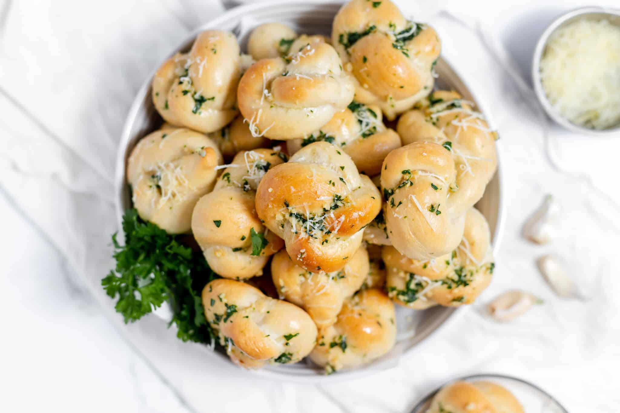 A pile of bread rolls on a plate.