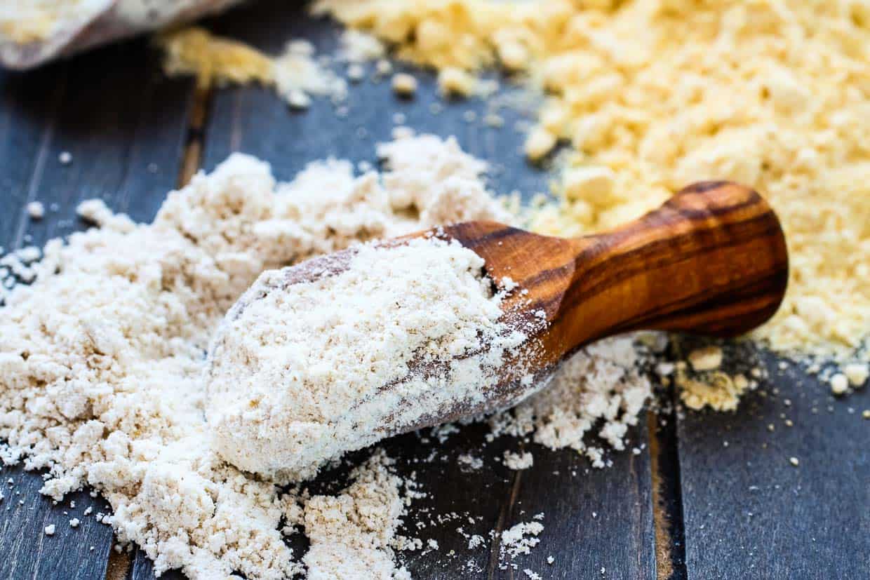 Gluten free oat flour in wooden scoop.