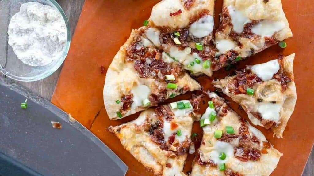 Sliced whole bacon jam pizza.