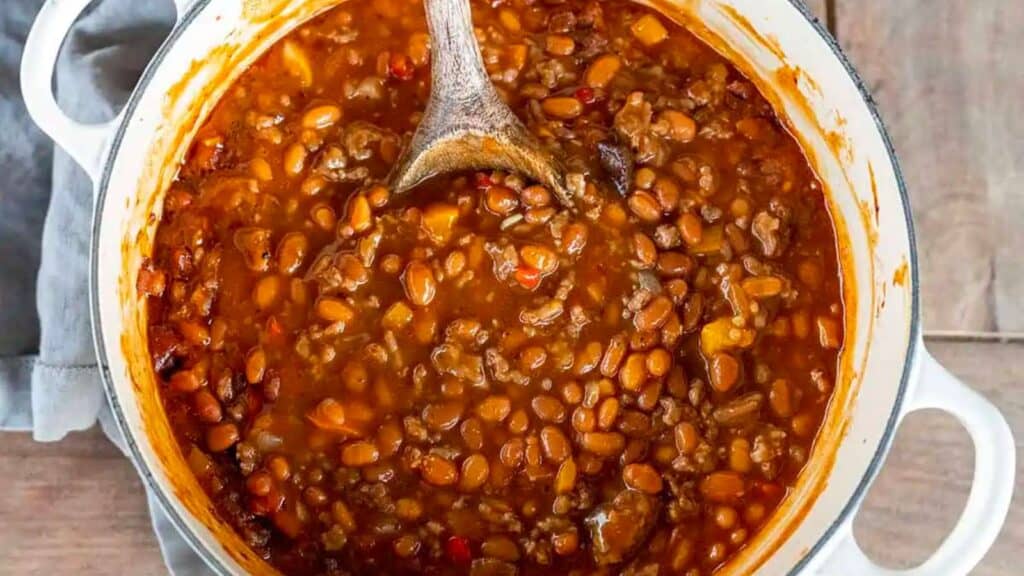 Spoon in pot of baked beans.