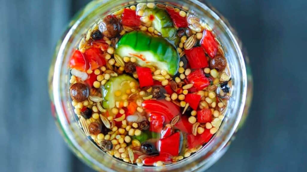 Overhead view of jar of bread and butter pickles.