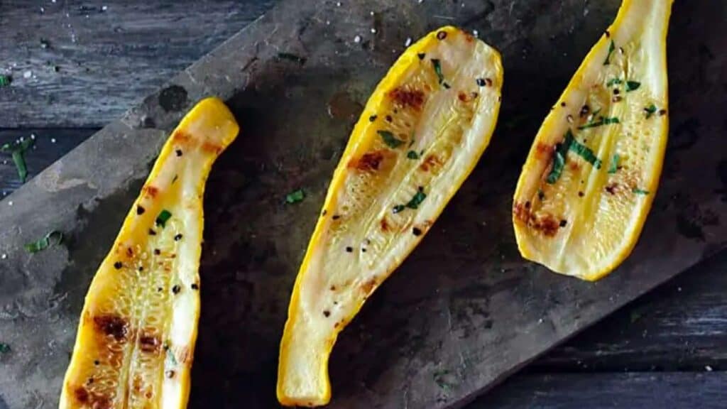 three grilled yellow squash halves.