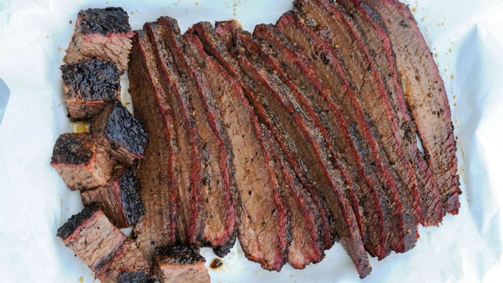 Slices and cubes of smoked brisket.