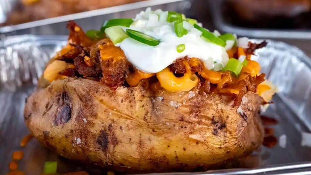 Baked potato loaded with meat, macaroni and sour cream.