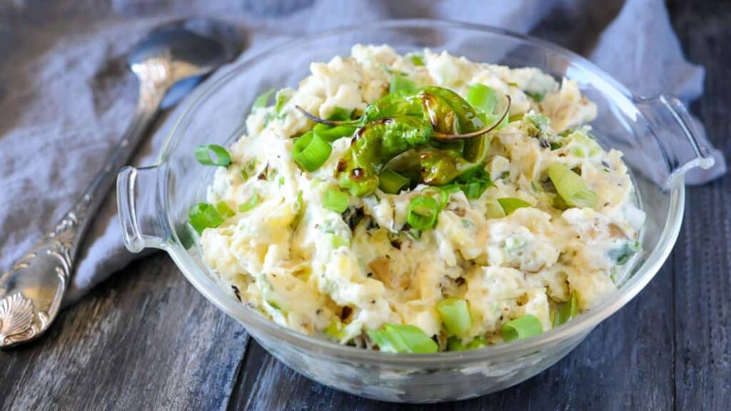 Bowl of potato salad made with grilled shishito peppers.