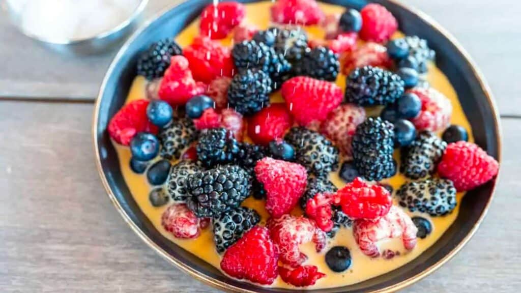 Bowl of berries surrounded by smoked bourbon sabayon.