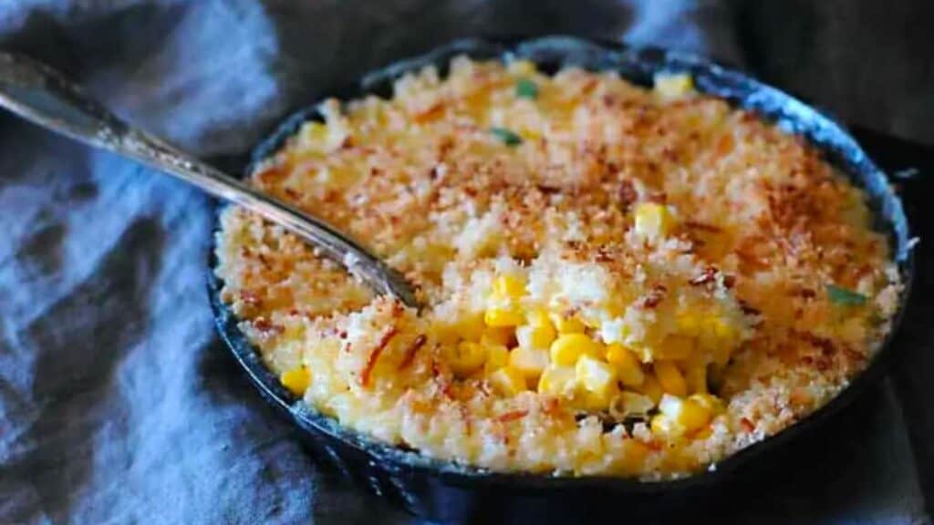 Spoon scooping out sous vide cream corn.