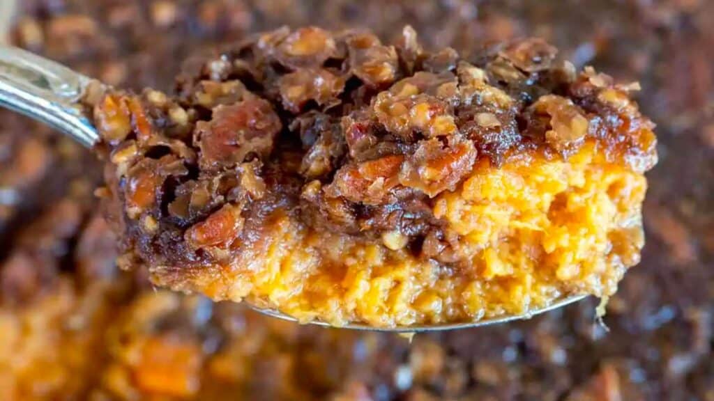 Spoon scooping out sweet potato casserole.