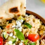 Healthy and easy, this Greek Quinoa Salad with homemade vinaigrette features fresh vegetables, cannellini beans and feta cheese topped with a zesty homemade vinaigrette. Serve on its own for a vegetarian dinner or as a side dish.