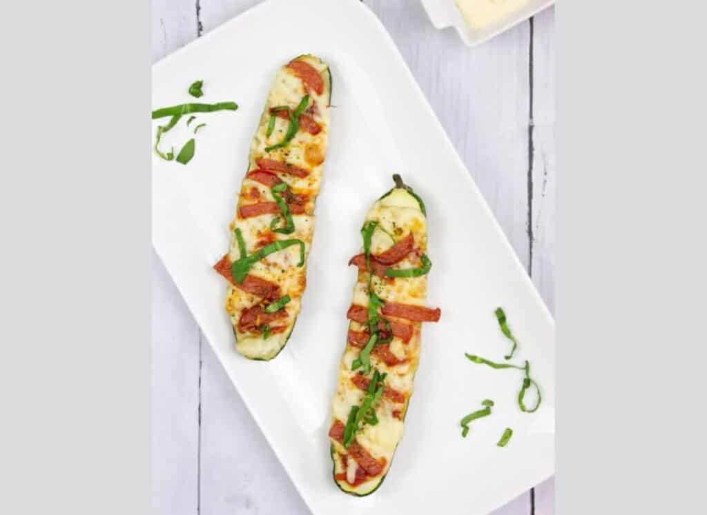 Zucchini Pizza Boats on a white plate.