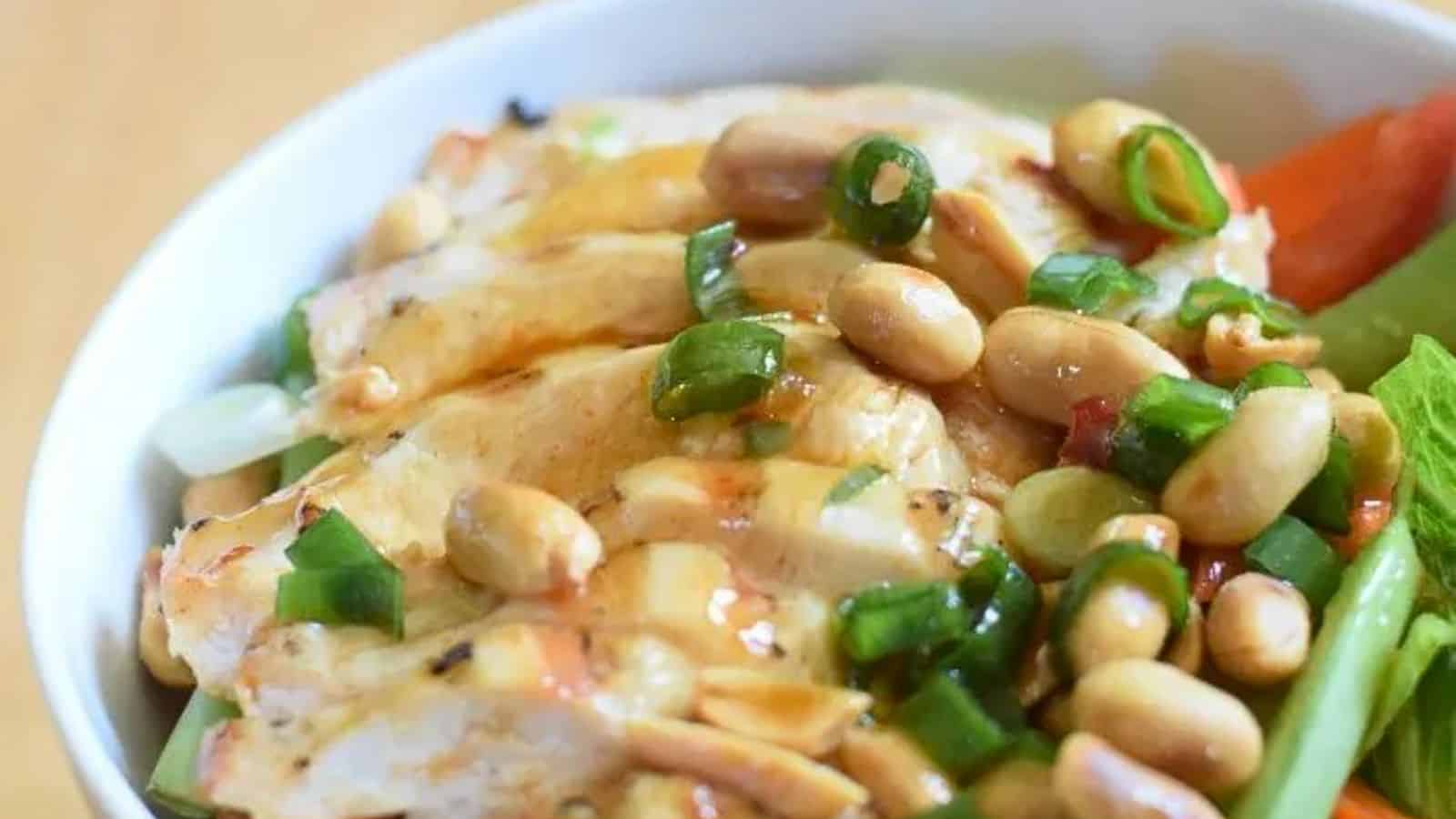 Image shows a closeup of Kung Pao Chicken Salad in a white bowl.