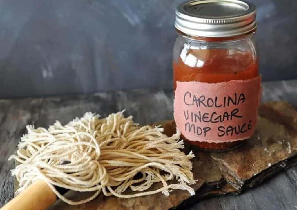 Jar of mop sauce with brush.