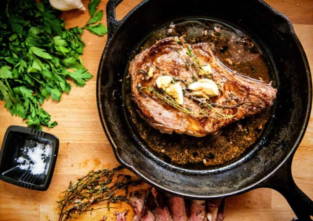 Ribeye in cast iron pan.