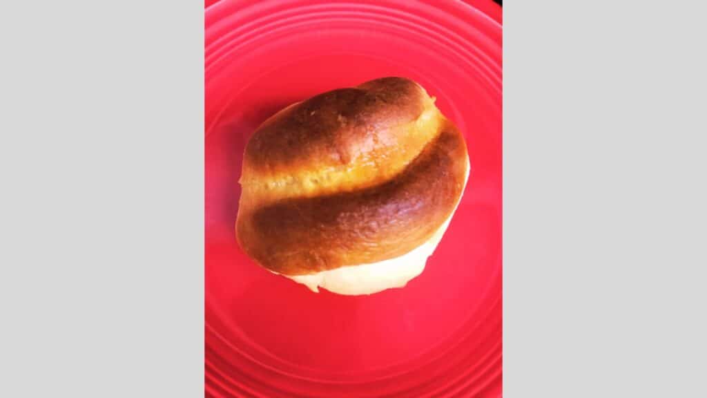 Parker House roll on red plate.