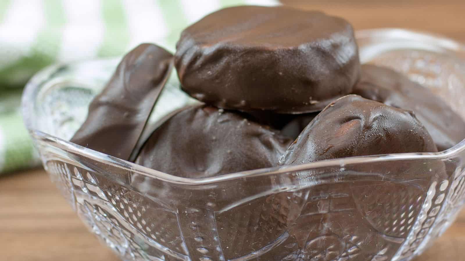Close up of six peppermint patties in a glass bowl.