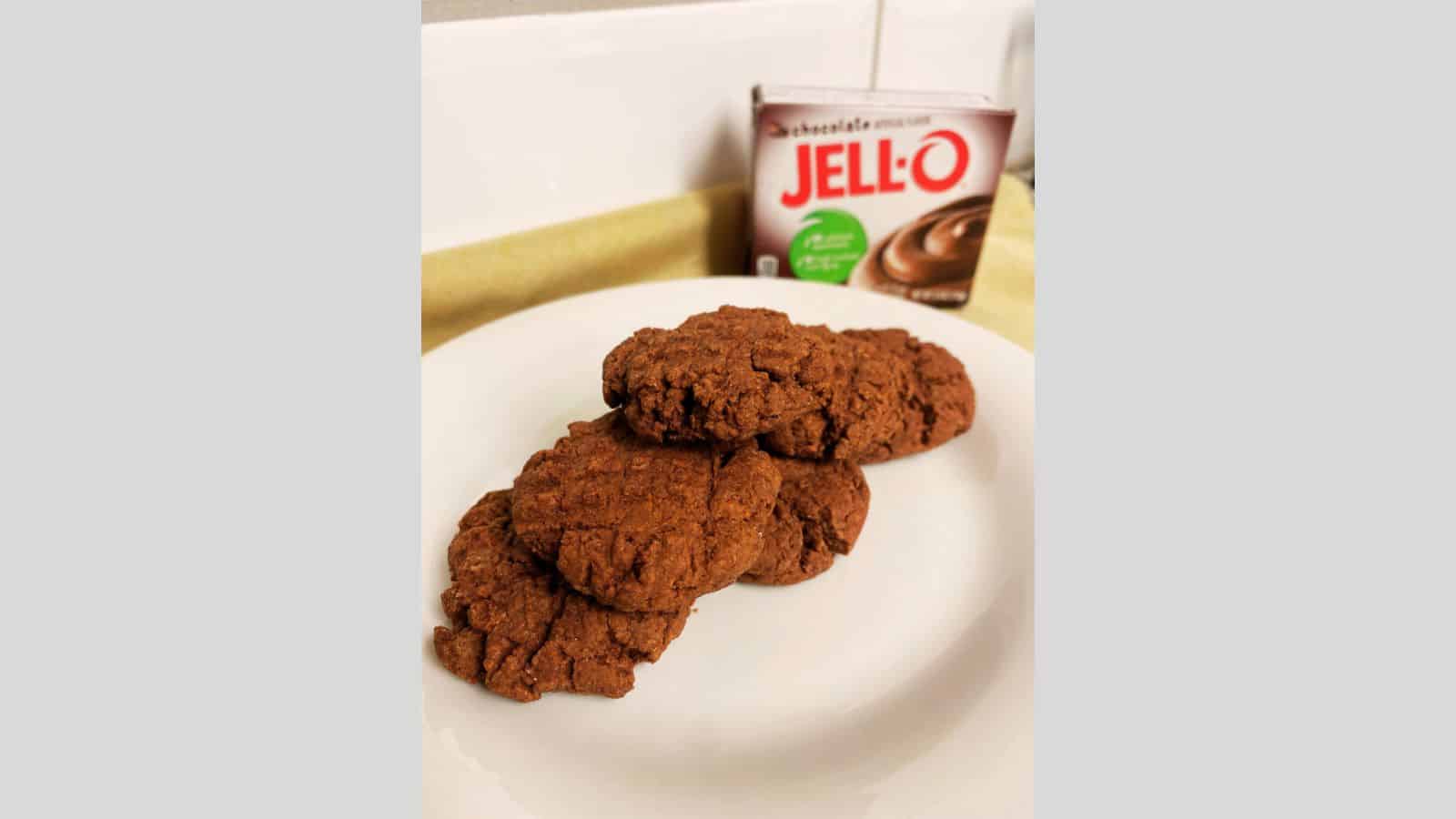 Chocolate pudding cookies piled on white plate.