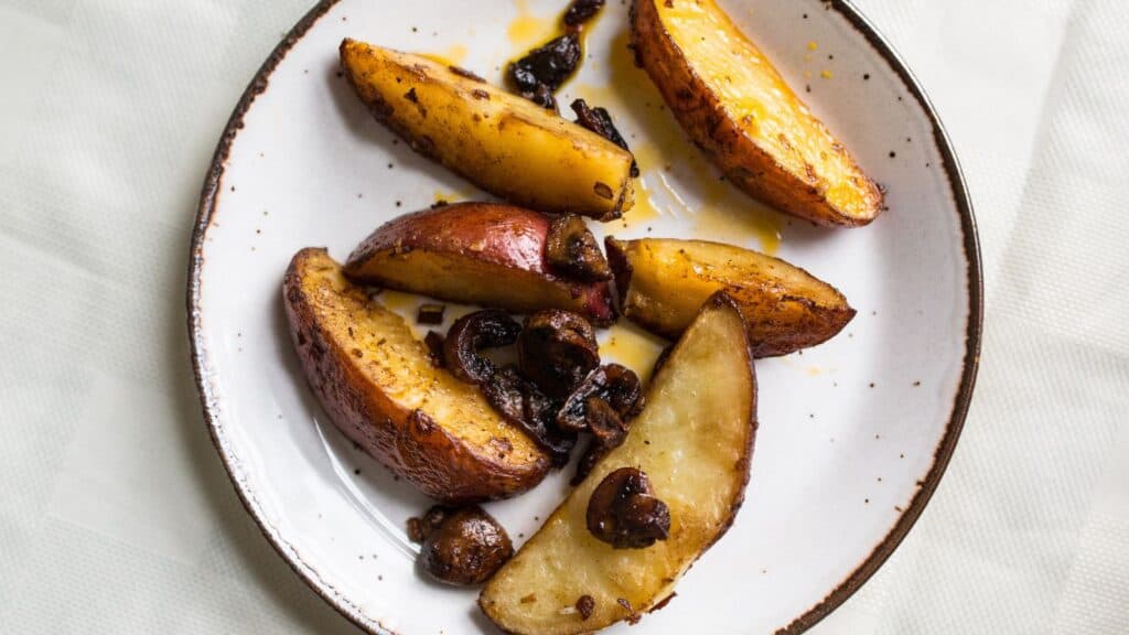 Overhead view of plate of potatoes and mushrooms.