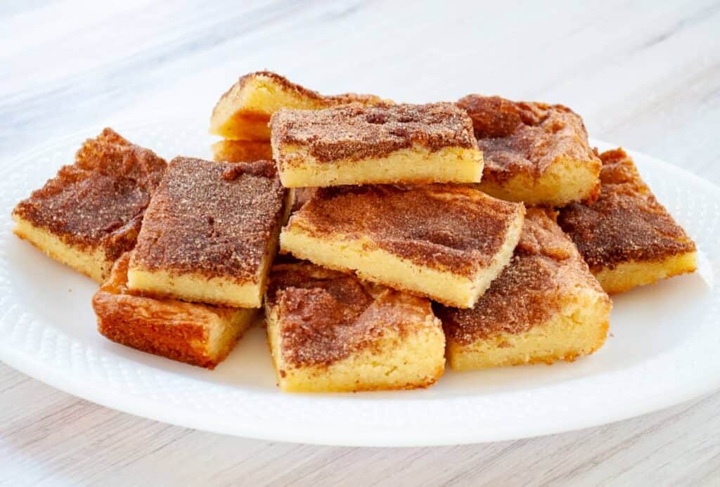 A stack of Snickerdoodle Bars on a white platter.