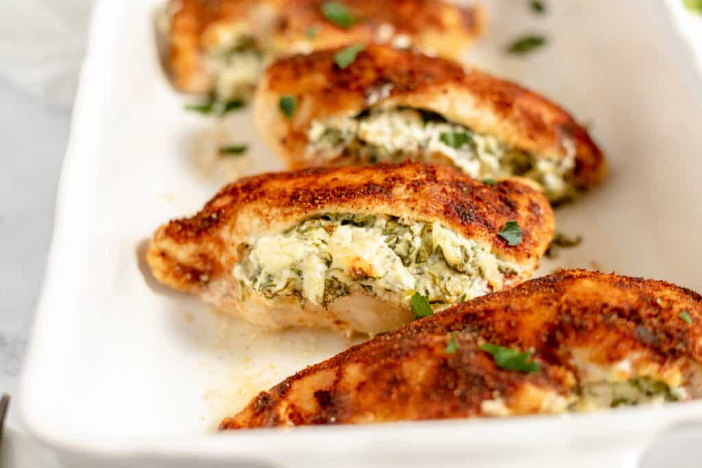 Stuffed chicken in a serving dish.