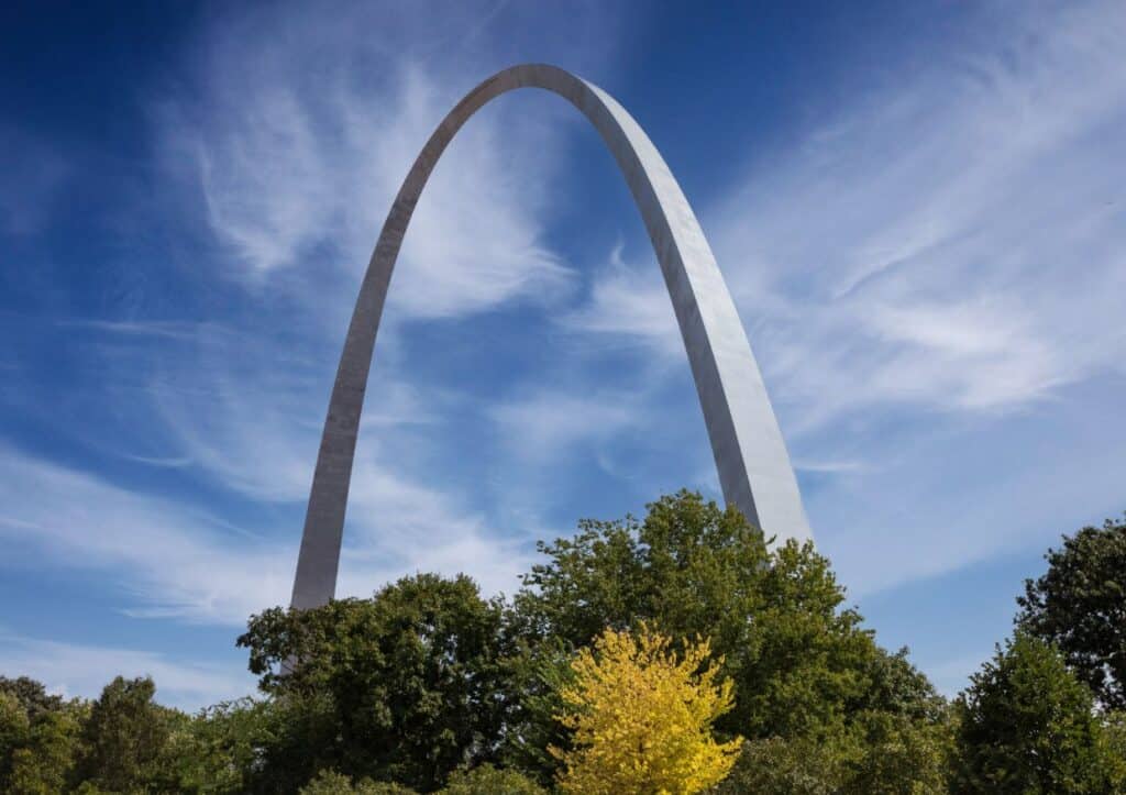 The Gateway Arch surrounded by trees.