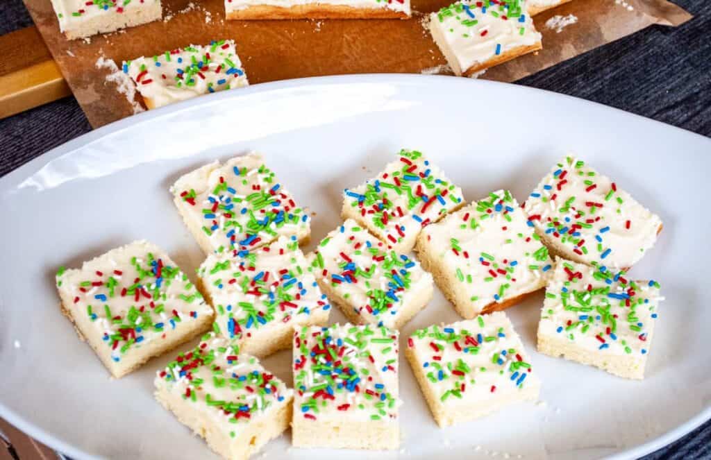 A platter with sugar cookie bars on it.