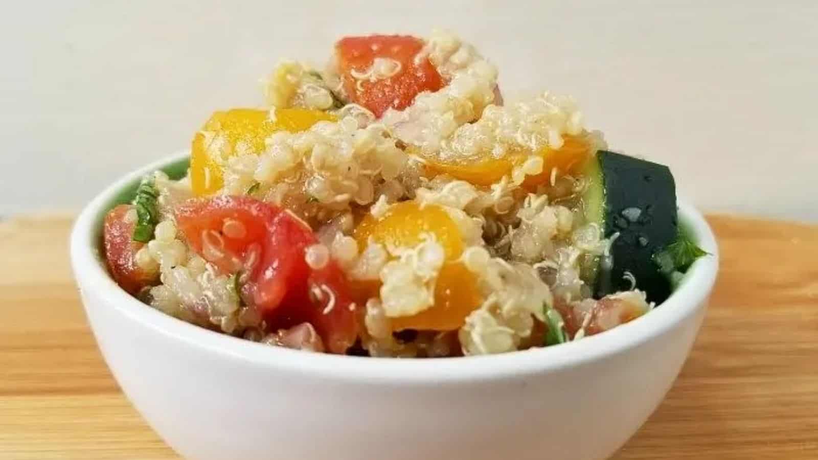 Image shows shows a closeup of Tomato Quinoa Salad in a small white bowl.