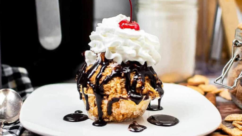 Air fryer fried ice cream on a white plate.
