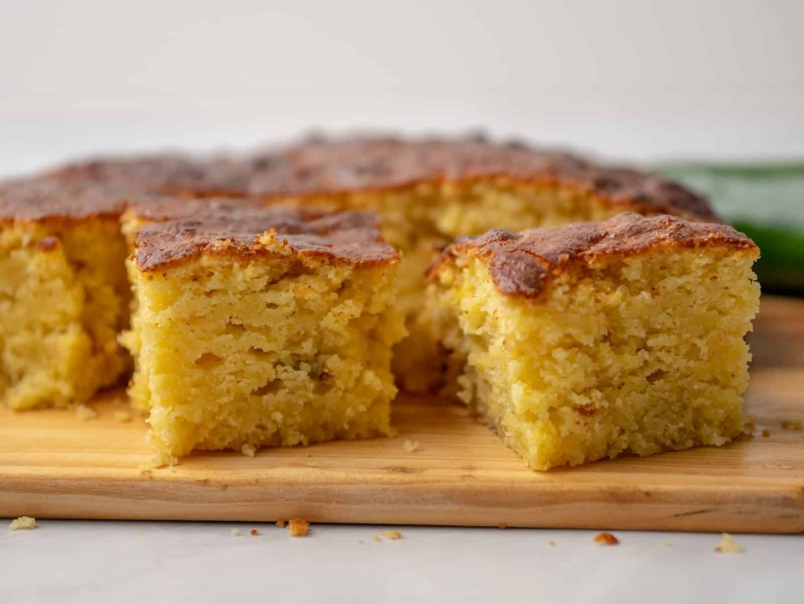 Slices of air fryer cornbread sitting on a cutting board.