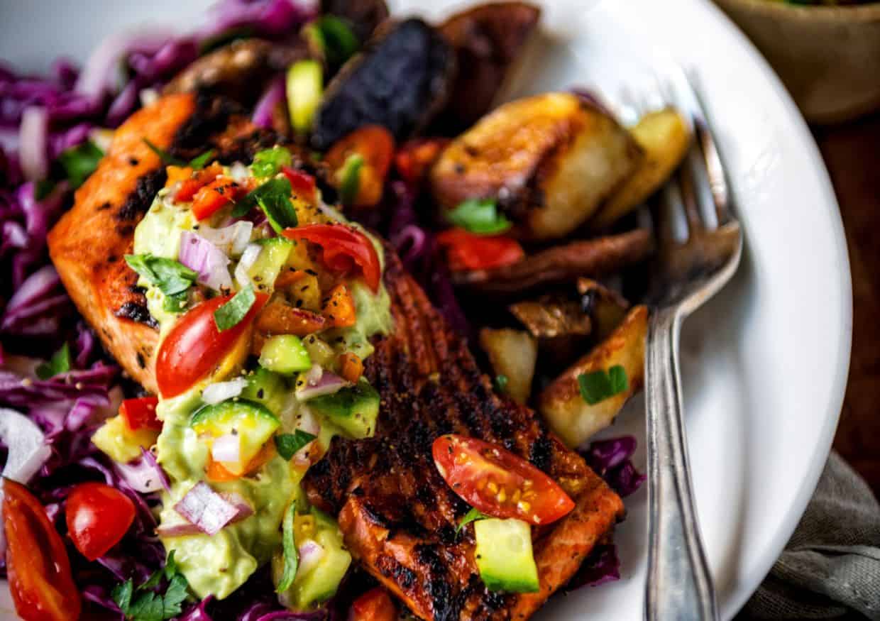 Color platter of blackened salmon with toppings. 