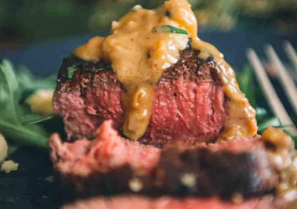 Close up of filet with sauce on top.
