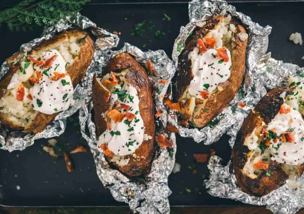 Baked potatoes unwrapped from foil.