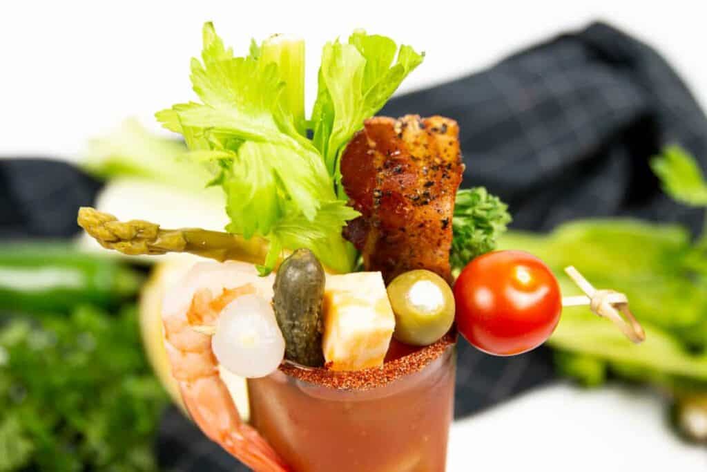 Bacon, celery, cheese, pickles, tomato, celery, asparagus and shrimp garnishes on a classic Bloody Mary. 