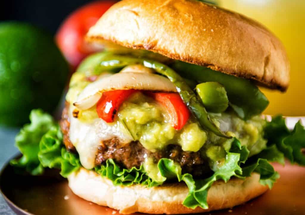 Close up on burger with fajita toppings.