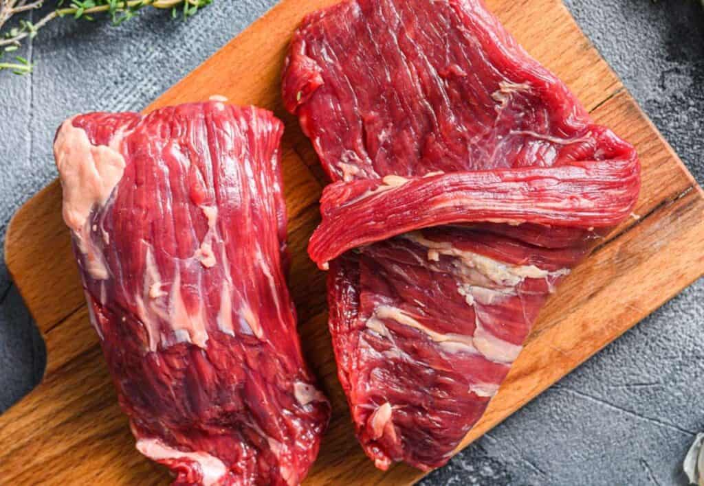 Flank steak on a cutting board.