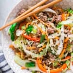 Ground beef cabbage stir fry in a bowl with chopsticks.