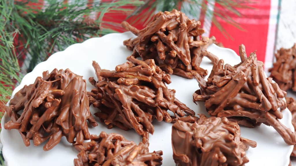 No bake haystack cookies on a white cake stand.