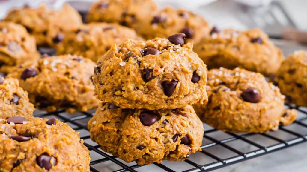 Pumpkin chocolate chip cookies on a wire rack.