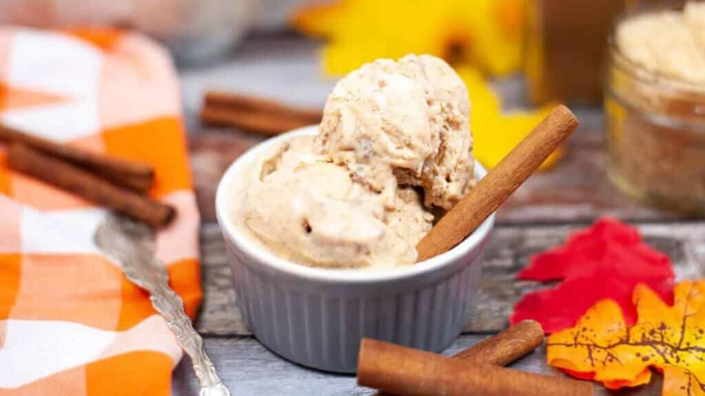 Pumpkin Spice Ice Cream in a white ramekin with cinnamon sticks.