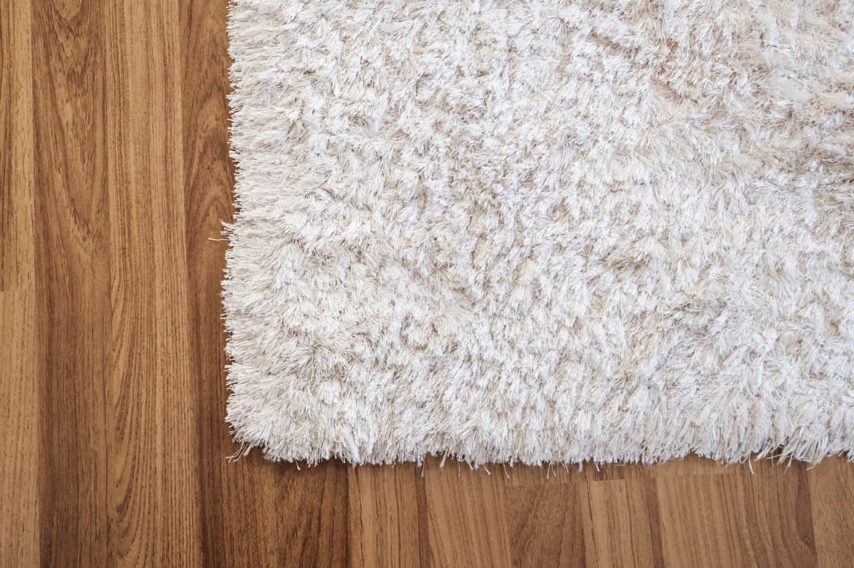 A picture of a shag rug cropped to show the bottom left corner.